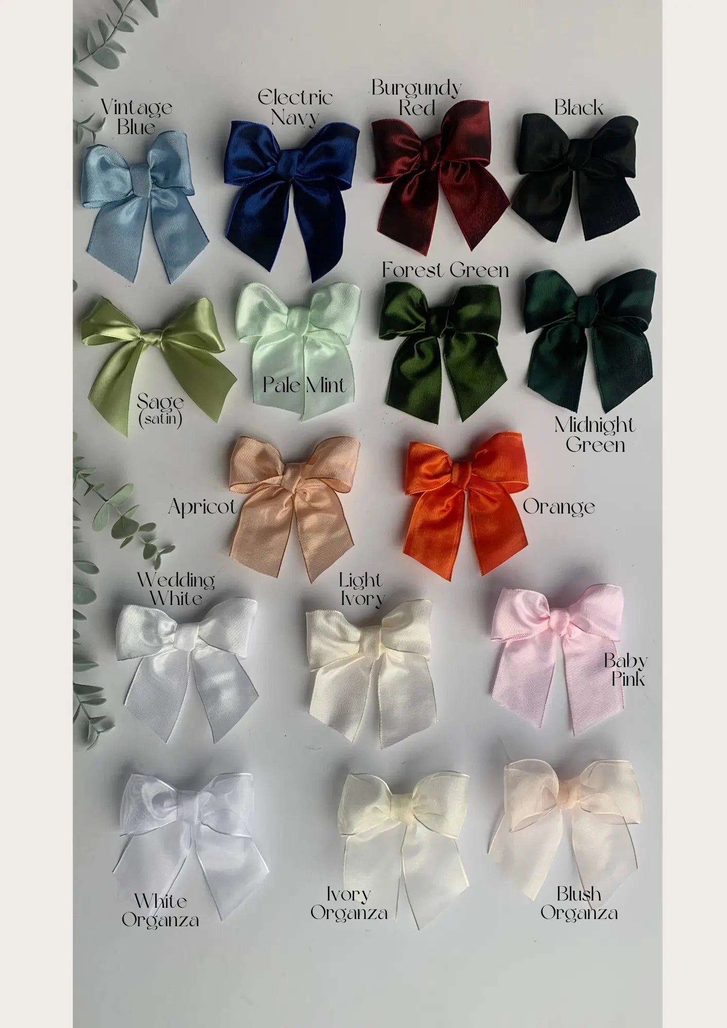 Collection of colorful bows with labeled colors on a light gray background
