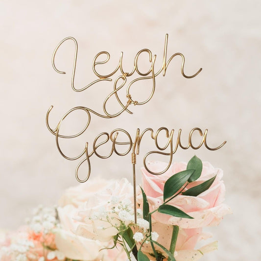 wedding cake topper in bronze gold wire, with couple’s names intertwined