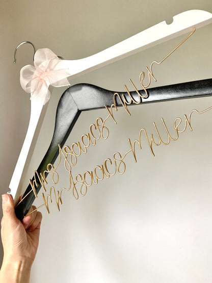 personalised wedding hangers for a bride and groom, with handcrafted wire lettering of couples’ new double-barrelled name