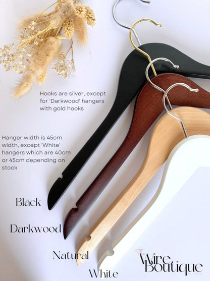 Choice of wooden hanger colours - black, dark wood, natural wood, and white