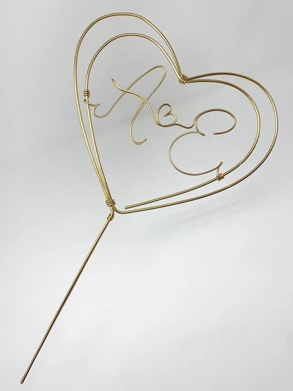 wire heart cake topper, with two letters inside for the newlywed couple