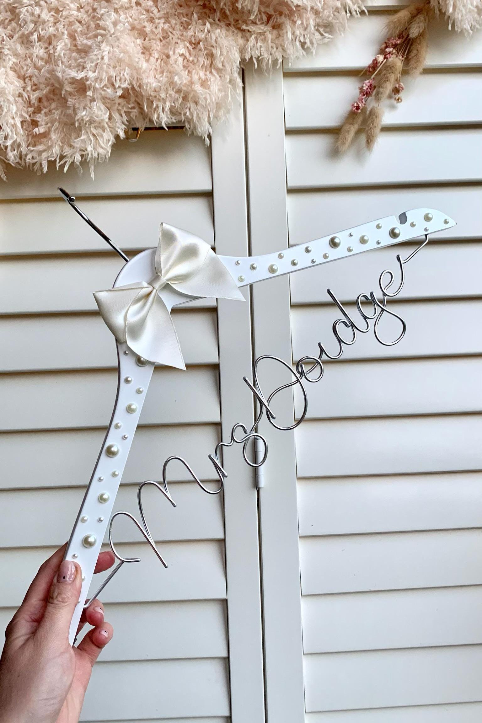 hanger for bride, with pearl detailing and ivory satin bow, and married surname handcrafted in silver wire